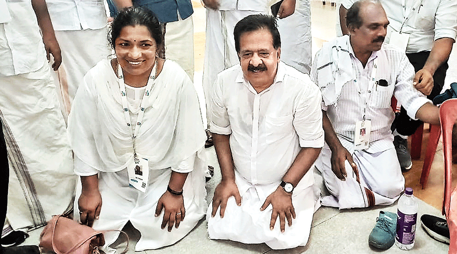 Congress leader Ramesh Chennithala shows yoga techniques to his party colleagues, including Youth Congress national secretary Vidya Balakrishnan, during the Bharat Jodo Yatra near Attingal, Thiruvananthapuram, on Tuesday.