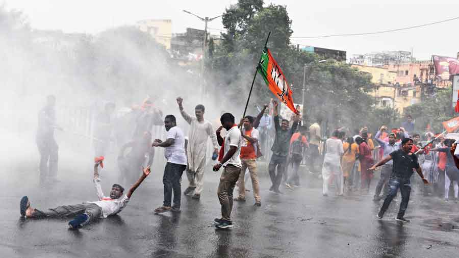 BJP workers get drenched in the water canon charge by the police during  the march on Tuesday. 