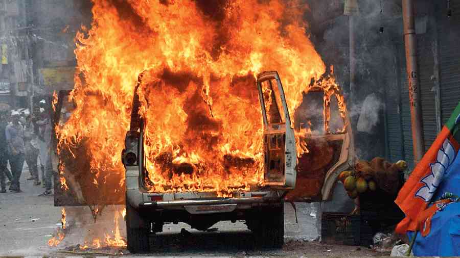 The police vehicle on fire near MG road in Calcutta on Tuesday