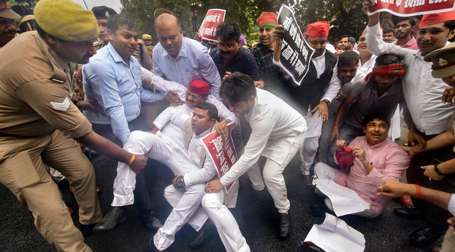 Samajwadi Party (SP) MLAs stage a protest against BJP government outside party HQ in Lucknow on Wednesday.