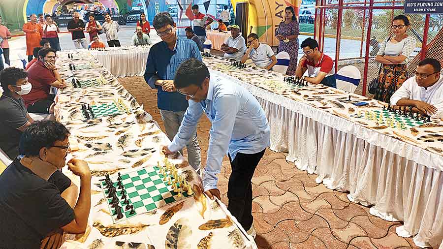 Grandmaster Dibyendu Barua mulls his next move against one of the 12 players playing simultaneously against him. 