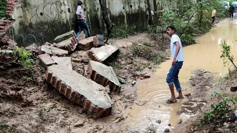  Debris lie on the ground after the boundary wall of an Army enclave collapsed due to heavy overnight rains, in Lucknow.