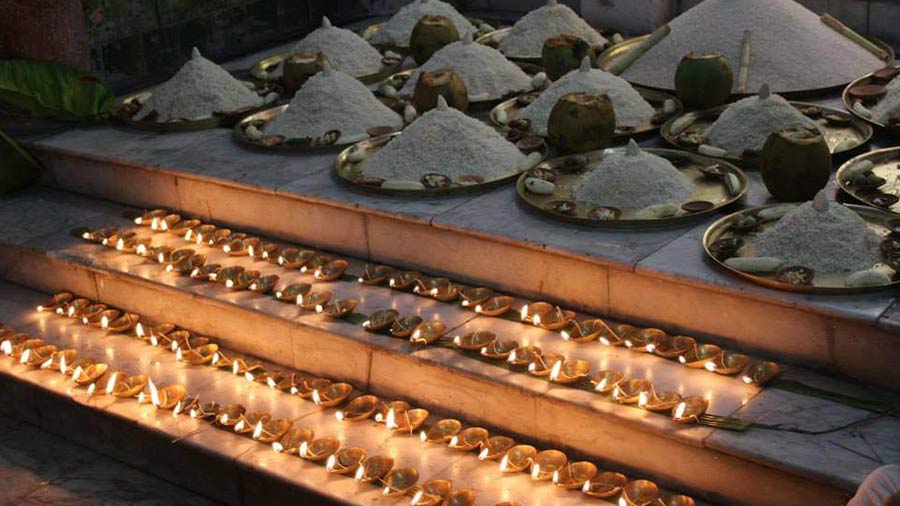 Earthen lamps and other offerings lined on the steps 