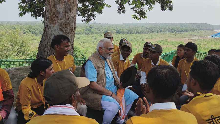 Prime Minister Narendra Modi interacts with workers at the Kuno National Park