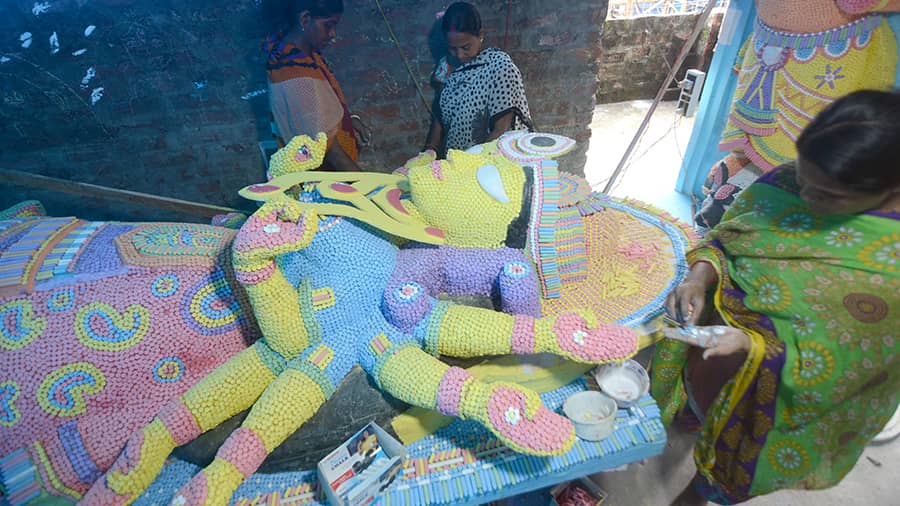 Artisans use chalk pencils to make an idol of Durga for a puja in north Kolkata on Saturday.