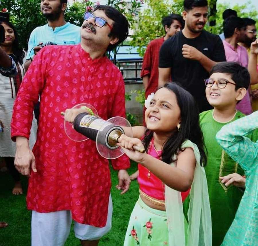 (Left) Film director Shiboprosad Mukherjee with a young kite flyer on the occasion of Vishwakarma puja on Saturday.