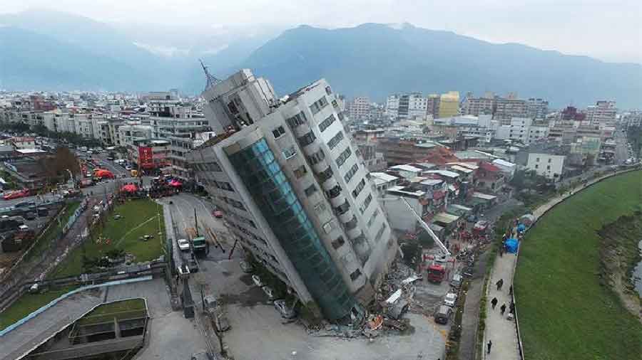 A building crumbles under the influence of the quake
