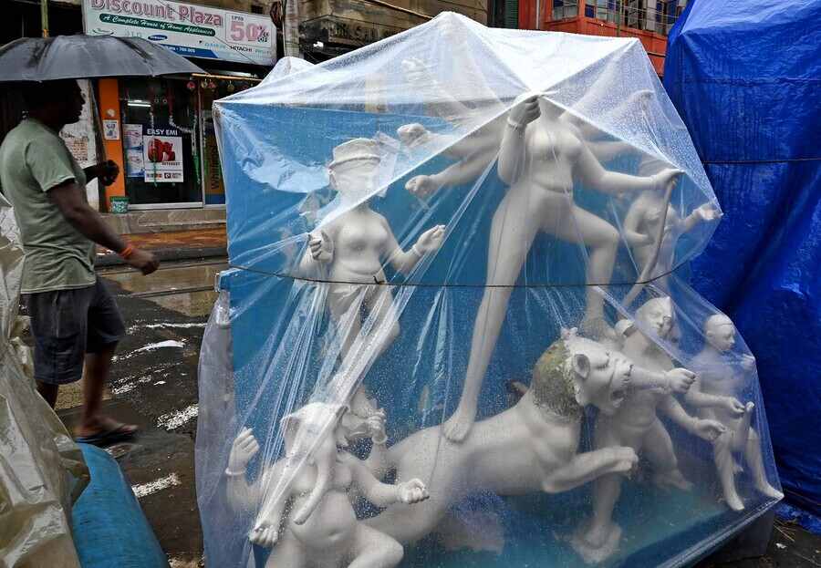 Plastic sheets protect half-finished idols from the rain at Kumartuli on Monday, September 12.