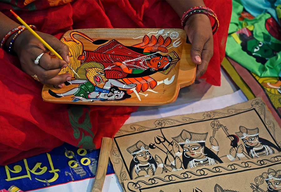 An artist paints the goddess Durga battling Mahishasur at a handicrafts fair in Kestopur on Thursday, September 15.