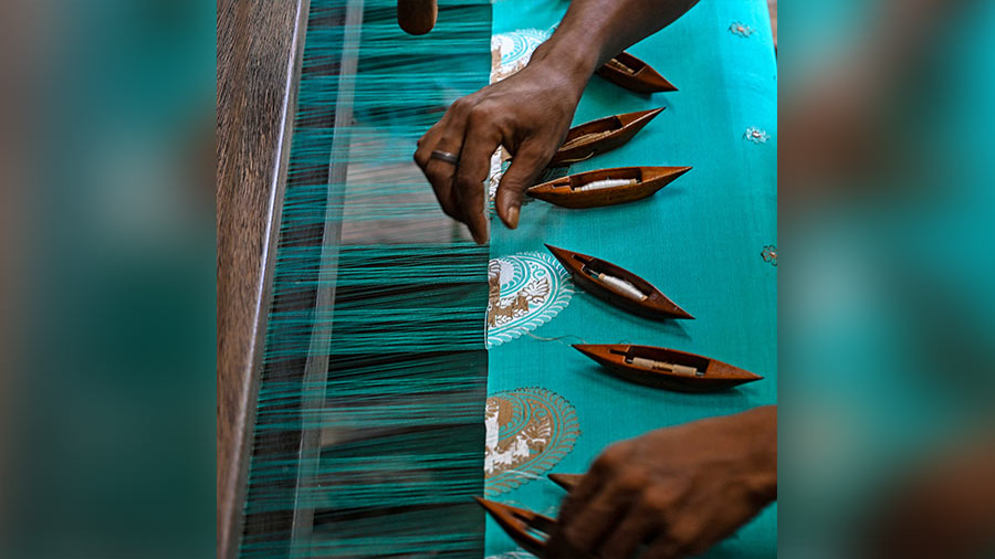 A motif is being woven in a sari by hand. Needle work is the most popular method in weaving Jamdani motifs by hand