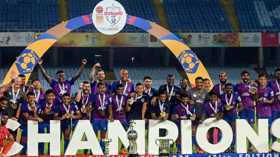 Bengaluru FC players pose with the Durand Cup-2022 trophy after defeating Mumbai City FC  at Vivekananda Yuba Bharati Krirangan stadium on Sunday