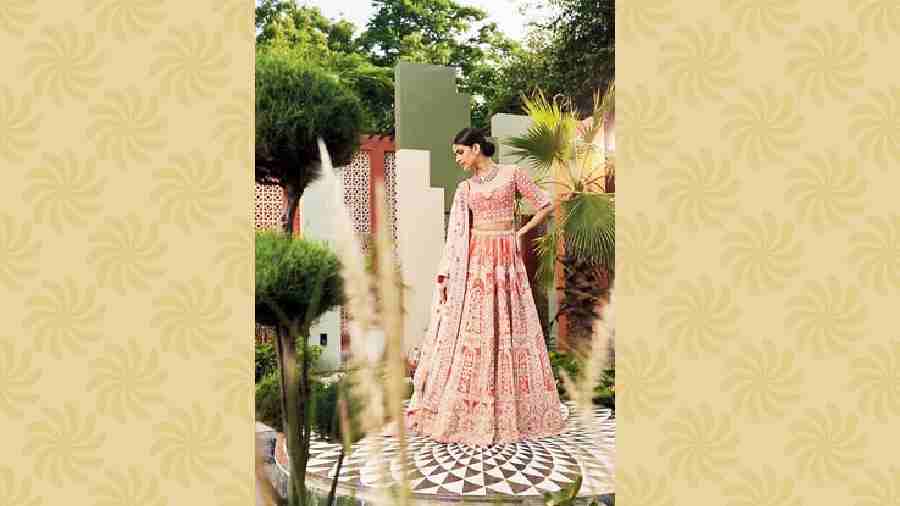 Pragya lehnga: This coral velvet lehnga is all about royal Persian motifs and is intricately hand-crafted with metal zari embroidery in zardozi. It has a matching choli in velvet with a deep neckline and geometric hand-embroidery work in floral design. The dupatta is embroidered with floral bootis. Price: Rs 2,25,000