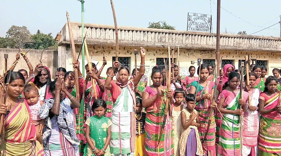Tribals with traditional weapons agitate for inclusion of Sarna in religion code of census near Jamshedpur last year.