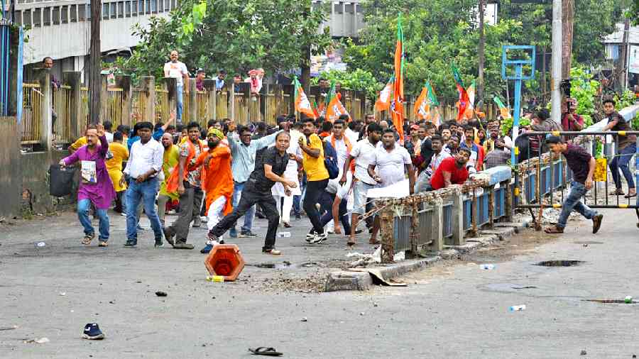 BJP supporters throw stones at the police from the base of the Brabourne Road flyover after being stopped from proceeding towards Nabanna last Tuesday