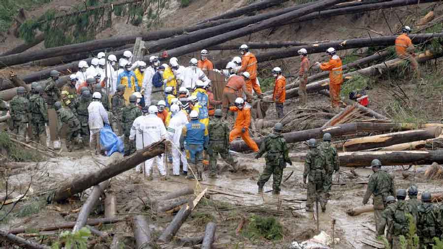 Workers conduct a search and rescue operation at a landslide site in Miyazaki Prefecture