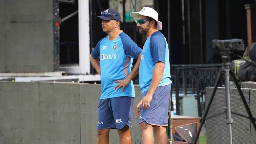 Skipper Rohit Sharma and coach Rahul Dravid observe as the players train