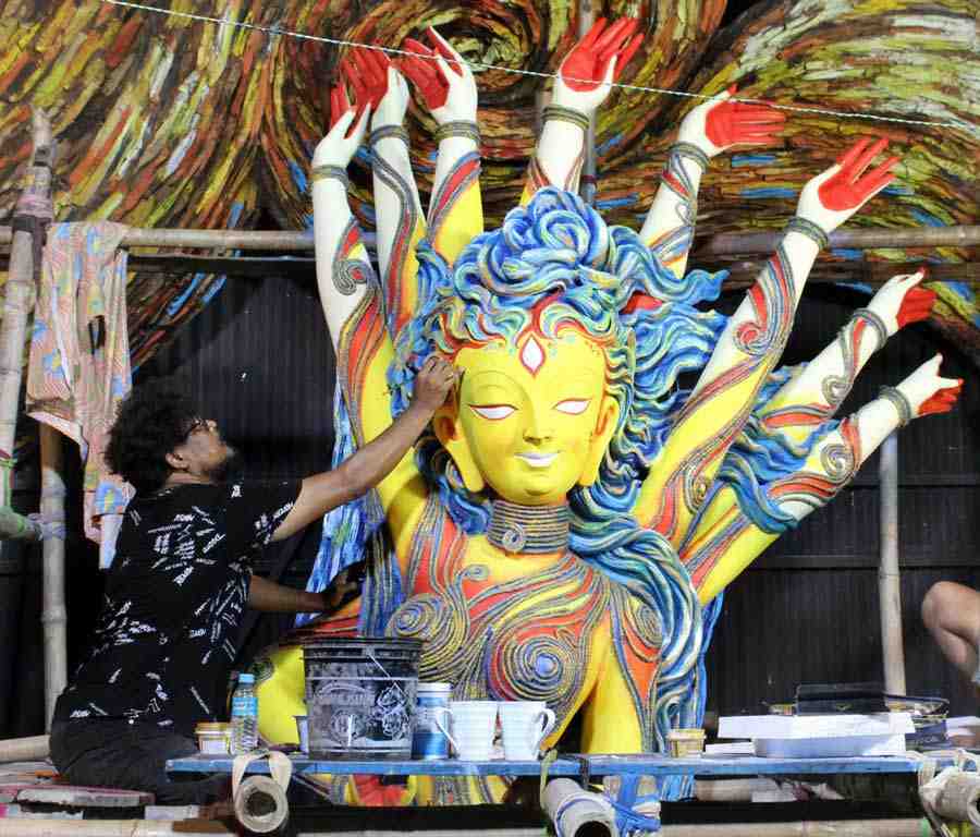 Artist Sanatan Dinda puts finishing touches to the clay model of Durga at Bakul Bagan Sarbojanin, Kalighat on Monday. This year’s theme of the Puja is ‘Akash bhora surjo tara, biswa bhora pran.’