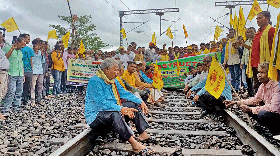 Organisations demanding the ST status for the Kurmi community squat on railway tracks at Chandil  in Jharkhand on Tuesday.