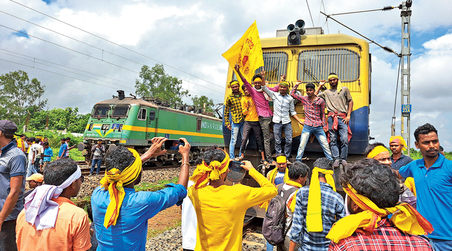 Members of the Kurmi community block railway tracks in West Midnapore on Tuesday.