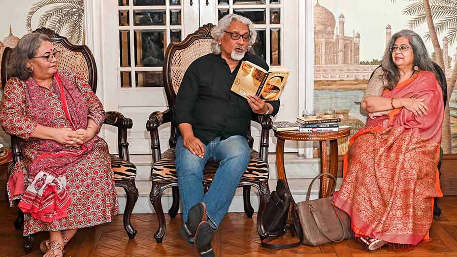 Monideepa Banerjie and Anjum Katyal listen as Kunal Basu reads out an excerpt from his book, ‘Sarojini's Mother’, which is based in Kolkata