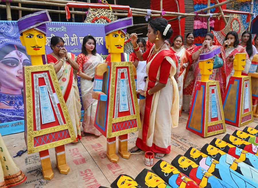 An artist paints an exhibit that will be used to decorate the Khudiram Colony Sarbojanin Durgotsav in Dum Dum on Thursday.