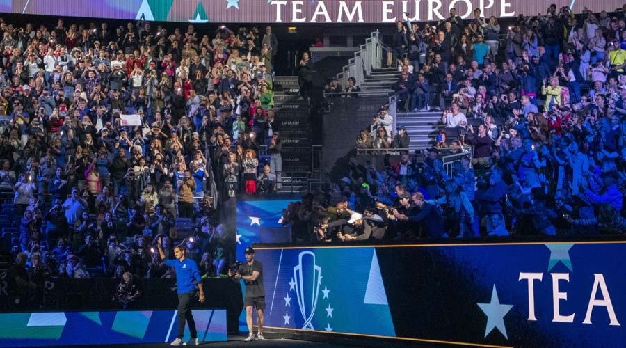 Roger Federer walks onto the court to join his Team Europe teammates at the Laver Cup 2022 in London on Friday