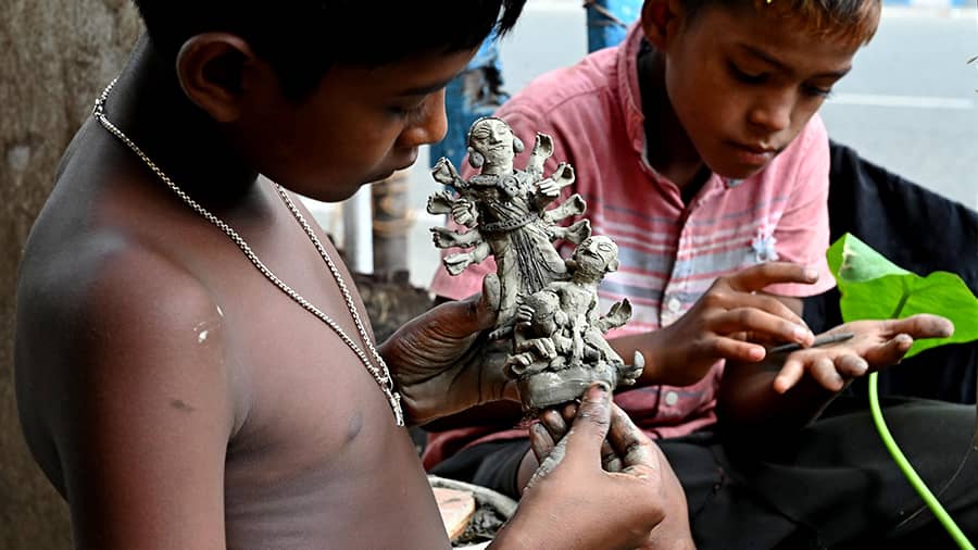 Kishore Sardar puts finishing touches to a mini Durga idol.