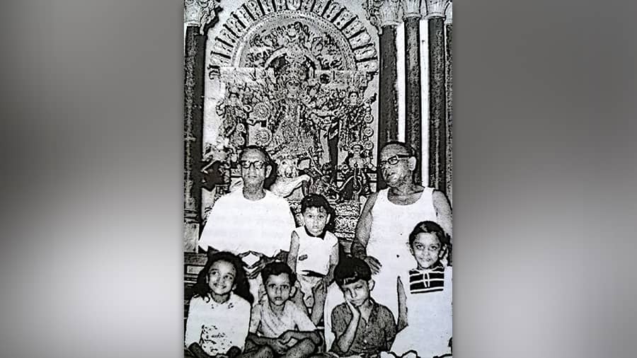 A photo from the late 1960s shows members of the Sen family posing in front of their Durga idol 