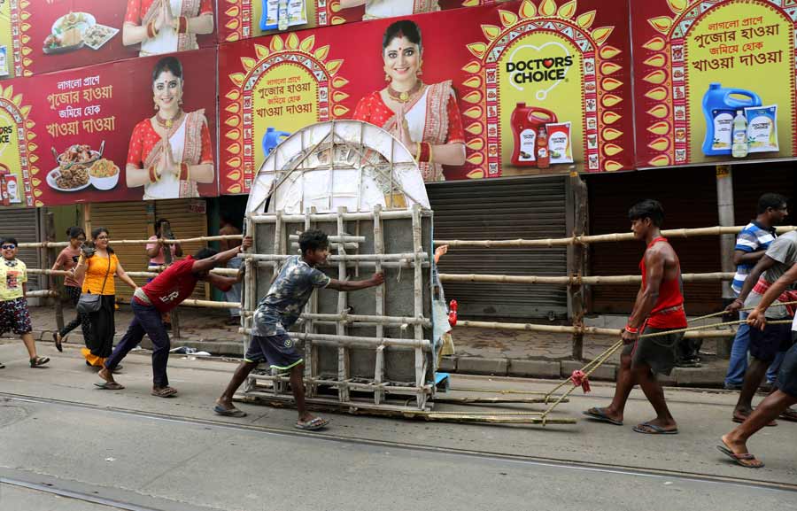 An ekchala Durga idol being ferried to a pandal. Most Puja committee members prefer to bring in their respective idols on Mahalaya.