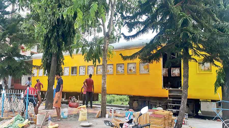 Workers refurbish a railway coach where the restaurant will be opened  at New Jalpaiguri station. 