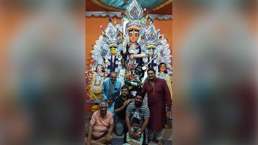 Family members pose in front of the idol