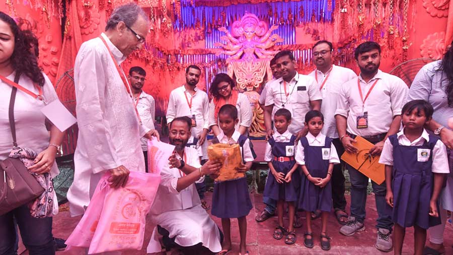 Children visit one of the nearby puja pandals
