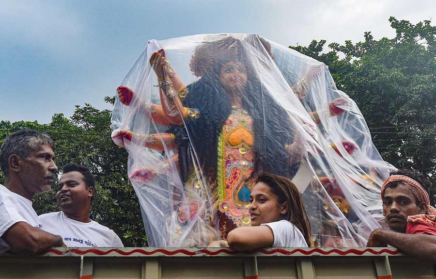 A plastic-wrapped idol of Goddess Durga being ferried to a puja pandal on Tuesday 