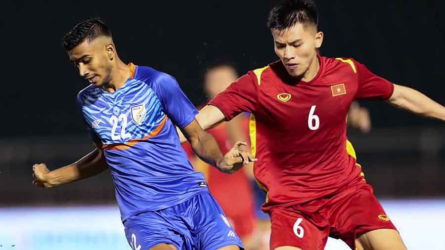 India's Ashique Kuruniyan (left) and Vietnam's Nguyen Thanh Binh vie for the ball during the Hung Thinh friendly football tournament match