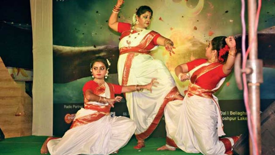 Dancers on stage strike a powerful pose replicating Ma Durga killing Mahishasur and a symbol of the victory of good over evil.