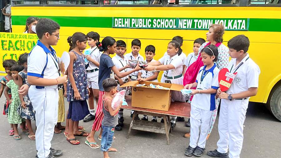Students distribute gifts to children near City Centre I