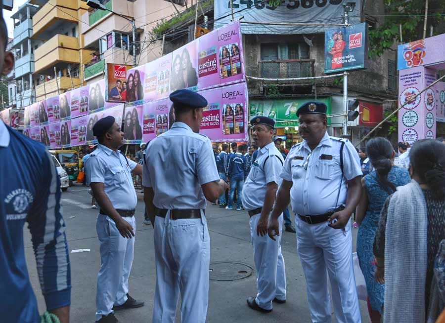 Policemen stand guard at a pandal in south Kolkata on Thursday. Security has been beefed up across Kolkata from Thursday for the Durga Puja festivities as revellers have already started making a beeline for popular pandals. A total of 17,000 police personnel, including 10,000 home guards, have been posted across the city and 400 pickets have been set up at various locations, while 58 PCR vans and 41 quick response teams have been deployed.