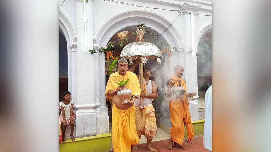 The priest carrying holy silver ghot
