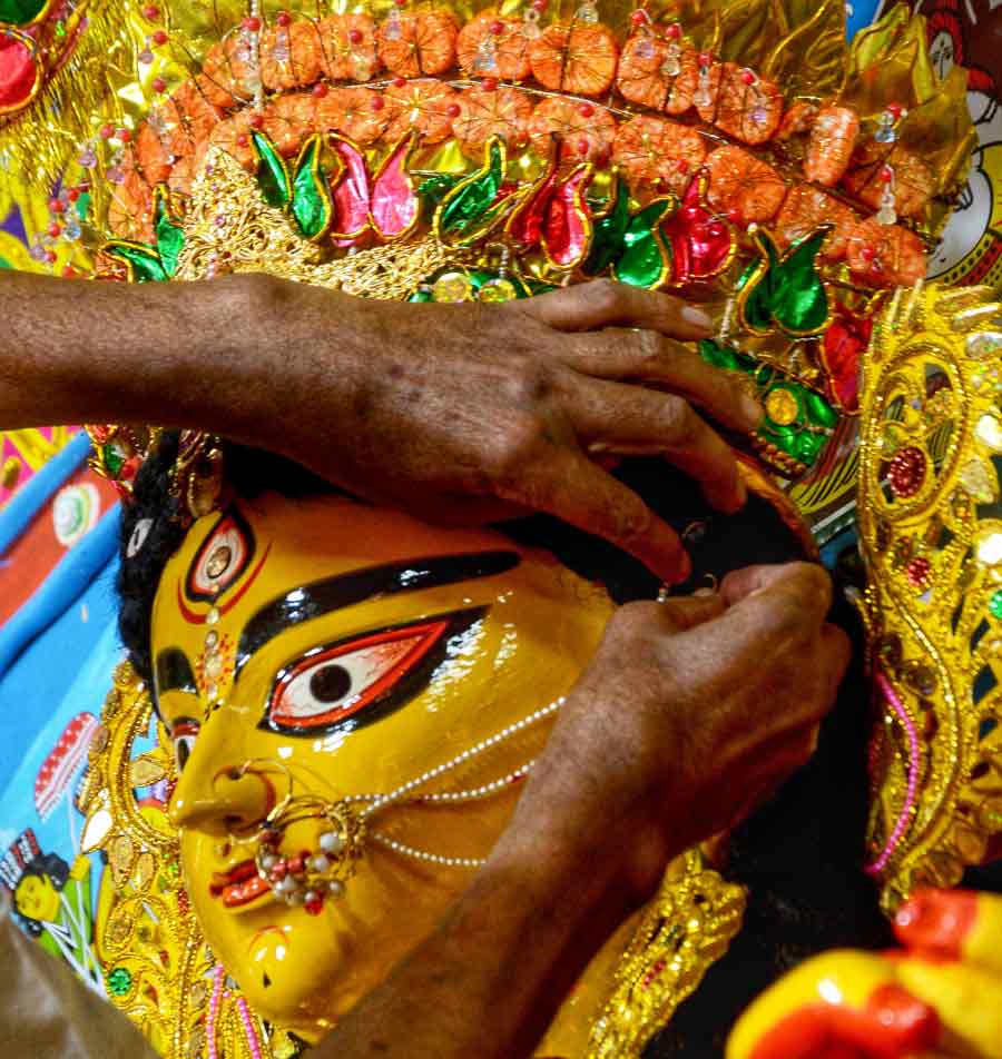 The Durga idol at Sovabazar Rajbari being adorned with jewellery on Friday.
