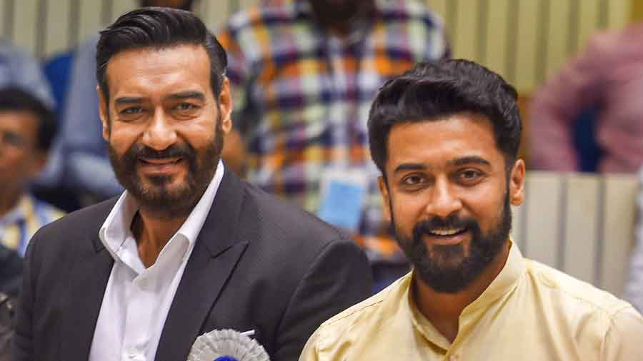 Joint winners of Best Actor Award Ajay Devgn (L) and Suriya strike a pose 
