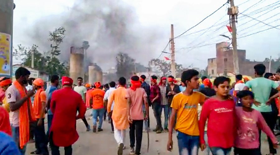 Locals at the site after clashes broke out between two groups during a procession a day after 'Ram Navami', in Nalanda district.