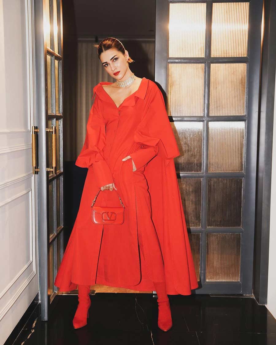 Kriti Sanon turned heads in an all-red Maison Valentino look — a red jacket dress paired with Valentino boots, purse and a diamond choker. 