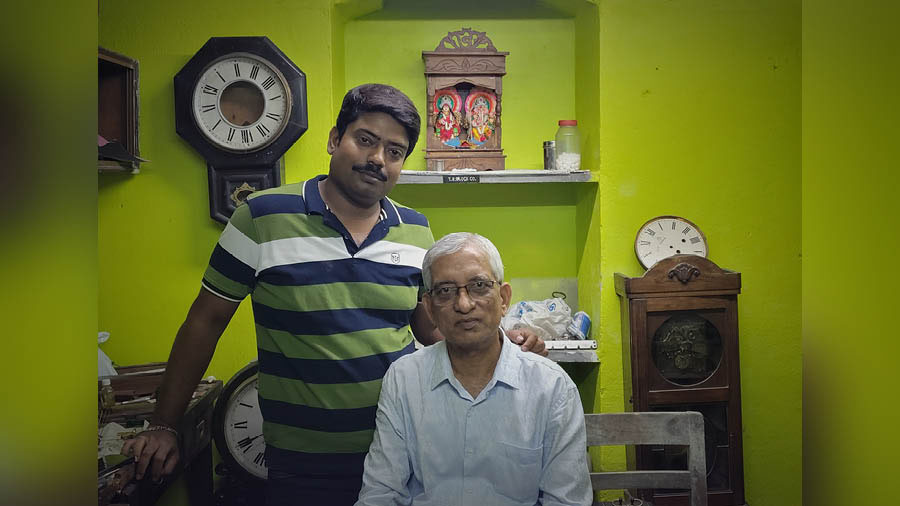 Swapan Dutta (right) has passed on much of his clock expertise to his son Satyajit (left) 