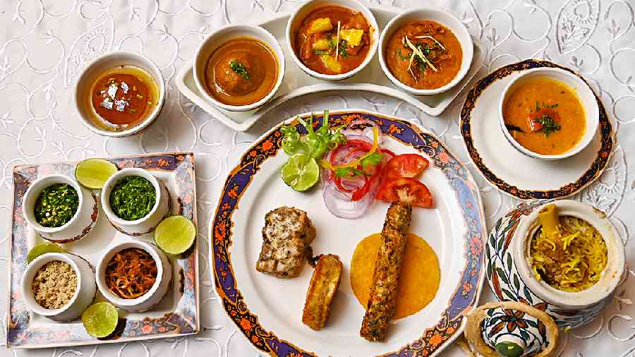 Here’s the complete non-vegetarian spread that you can experience as part of the Ruhaaniyat set menu. On the plate are signature kebabs, slow cooked to perfection, ranging from the Mahasir- a fish kebab that has a dominant seasoning of fennel seeds, the Dudhiya Kebab- a rich cottage cheese sandwich-style kebab that has spicy potato filling on the inside, and Gilafi Seekh Kebab which has chicken mixed with bell peppers that create a melt-in-the-mouth kebab and is served with baby sheermal bread.For the mains, there is an individual serving of the fragrant Dum Pukht biryani, where the mutton is so soft, it falls off the bone. Next to it is the Dal Dumpukht, a signature yellow dal of the restaurant, and inching close by is the Mutton Haleem. Murgh Narangi Qorma, a chicken gravy preparation that has the tang of fresh oranges is next to the haleem, along with the Mahi Kofta, a fish ball gravy that has the dominant base of onions and ginger garlic.The mains are served with breads such as Naan-e-Bakhummach, Warqi paratha and Khameeri roti.To finish off the meal, Shahd-e-Jaam, freshly made juicy gulab jamuns with a khoya and pistachio filling, are the ideal choice.