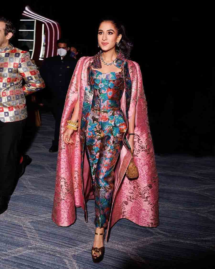 For the after-party, Radhika Merchant opted for a custom Dolce & Gabbana floral pantsuit paired with a pink cape and heirloom jewellery.  