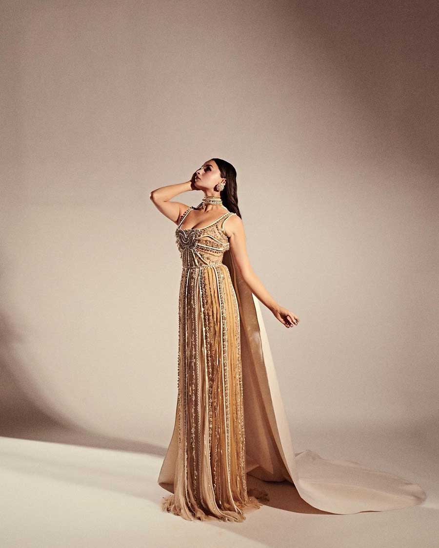 Alia Bhatt dazzled in a golden Elie Saab gown with a choker cape from the label’s Haute Couture Spring Summer 2023 collection. 