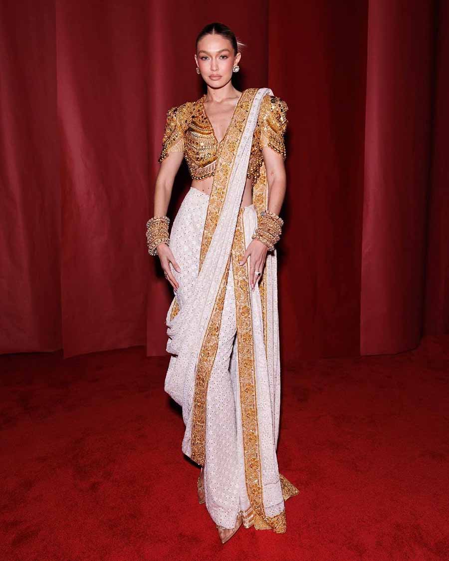 Gigi Hadid struck a desi girl pose in an Abu Jani Sandeep Khosla white chikankari sari with an embellished gold blouse and golden bangles. 