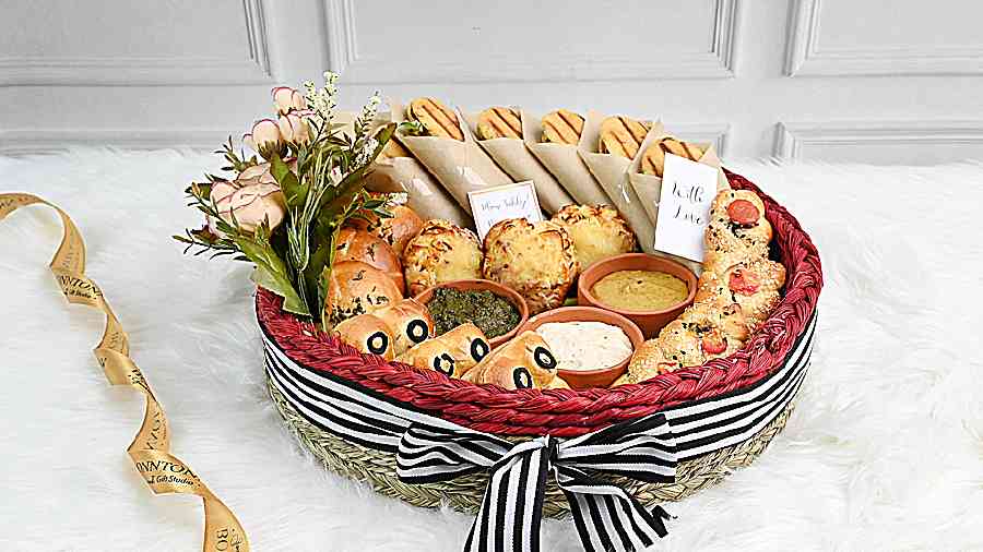 The fresh Bread Basket has assorted pillowy soft savouries like bagels, cream cheese buns, focaccia, and olive bread with fresh dips. Rs 1,290