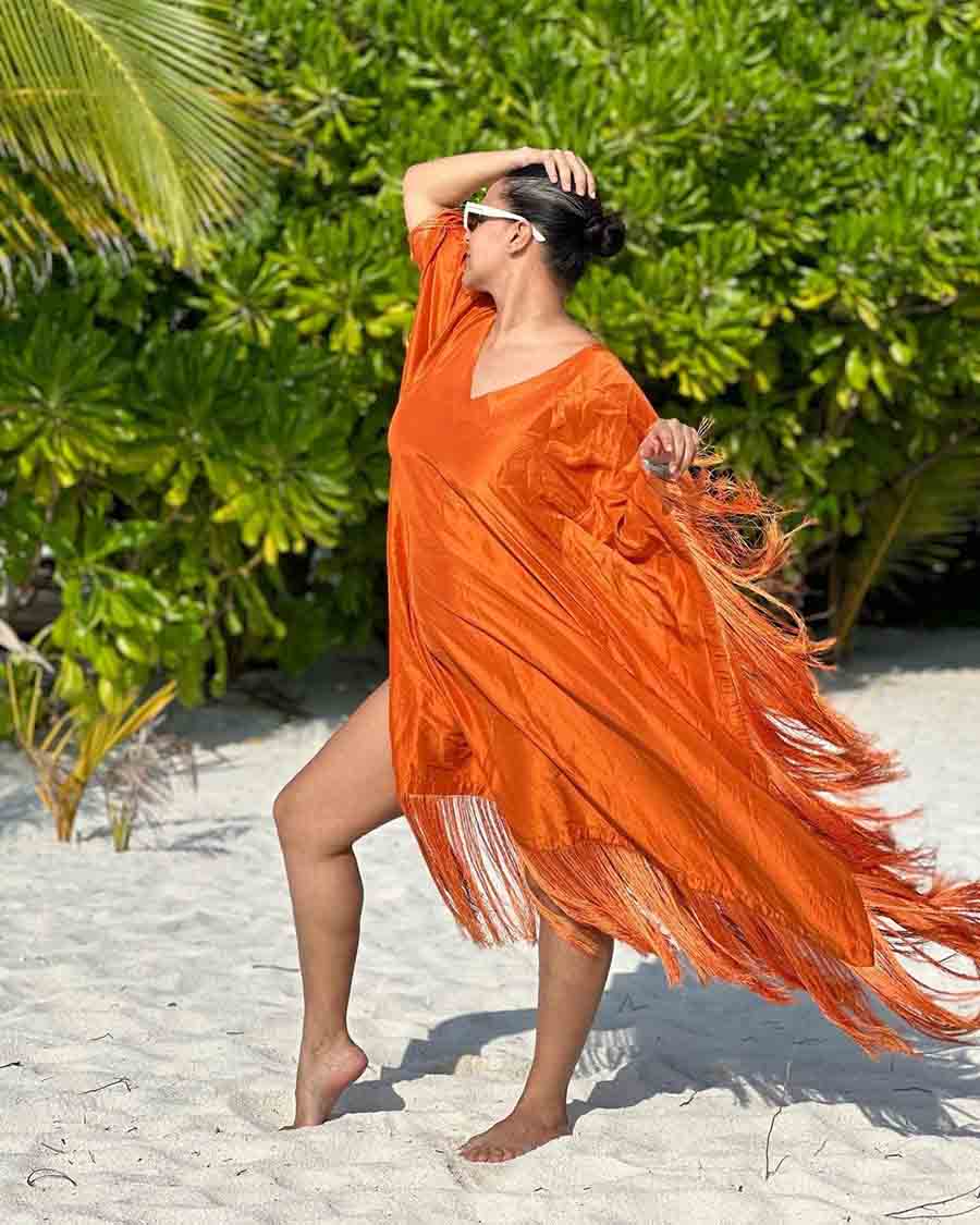 The Sheesha actress struck a pose in a bright orange Amrita Mehta dress with frills all over it.