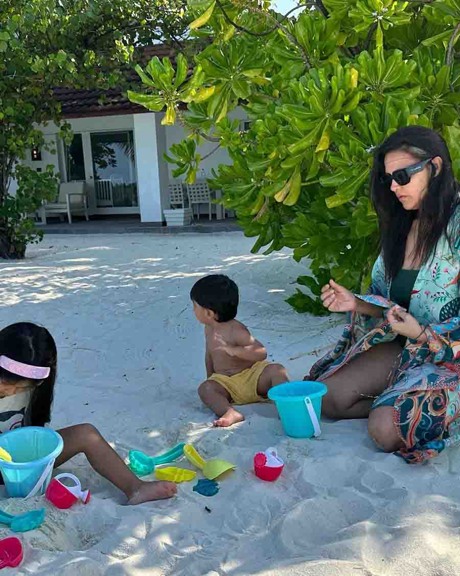 (L-R) Mehr, Guriq and Neha enjoy making sand castles on the beach. 